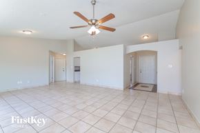 Orlando house for rent - an empty living room with a ceiling fan and a tiled floor