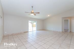 Orlando house for rent - an empty living room with a ceiling fan and a tiled floor