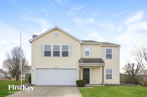 Plainfield house for rent - a yellow house with a white garage door