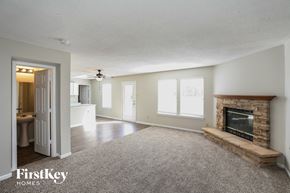 Plainfield house for rent - a living room with a fireplace and a carpeted floor