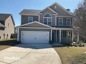 Moncks Corner house for rent - a house with a white garage door on a driveway