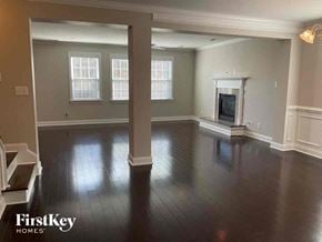 Moncks Corner house for rent - an empty living room with a fireplace and wooden floors