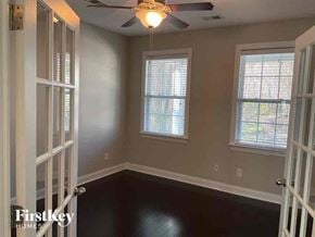 Moncks Corner house for rent - an empty room with a ceiling fan and two windows