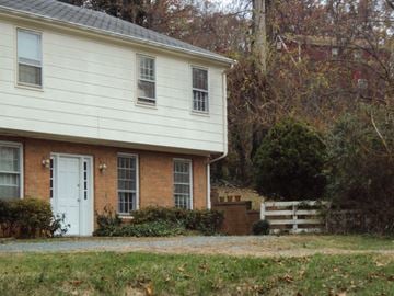 Charlottesville apartment for rent - the side of a house with a white door and a brick house