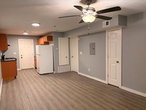 East Point apartment for rent - A room with a ceiling fan and a white refrigerator.