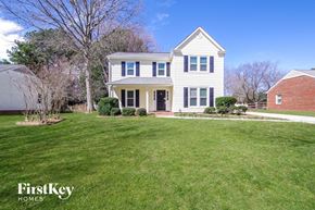 Charlotte house for rent - A white house with a large lawn in front of it.