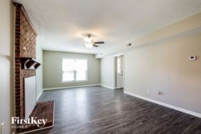 Charlotte house for rent - A room with a wooden floor and a ceiling fan.