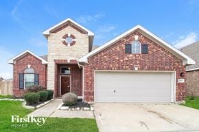 Baytown house for rent - a brick house with a white garage door in front of it