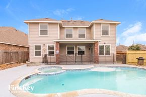 Baytown house for rent - a pool in front of a house with a swimming pool