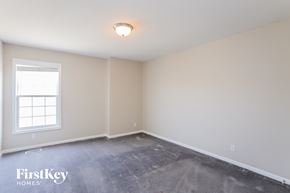 Kansas City house for rent - the living room of a home with a concrete floor and a window