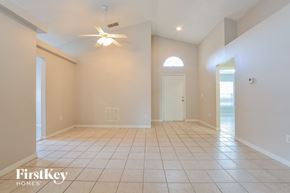 Poinciana house for rent - an empty living room with a ceiling fan