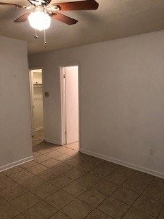 Baton Rouge apartment for rent - an empty living room with a ceiling fan