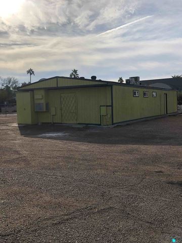 Phoenix apartment for rent - a green building in the middle of a dirt field