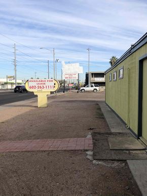 Phoenix apartment for rent - a sign sitting on the side of a street