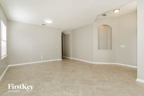 Jacksonville house for rent - A spacious empty room with a tiled floor and a doorway leading to another room.
