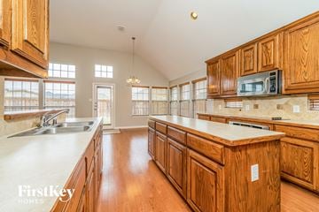 Mansfield house for rent - a large kitchen with wooden cabinets and counter tops and a sink