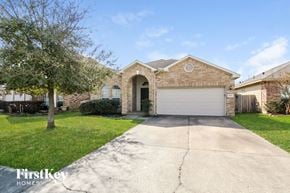 Highlands house for rent - a brick house with a driveway and a garage door