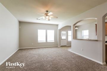 Highlands house for rent - a living room with carpet and a ceiling fan