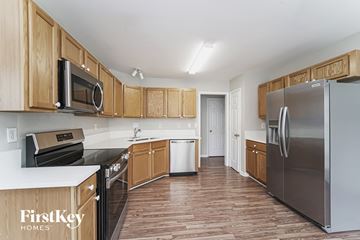 Mount Holly house for rent - a kitchen with wooden cabinets and stainless steel appliances