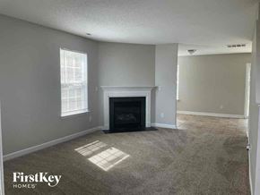 Charlotte house for rent - an empty living room with a fireplace