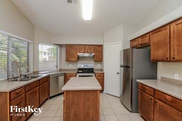Chandler house for rent - an updated kitchen with stainless steel appliances and wooden cabinets