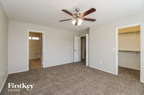 Chandler house for rent - a bedroom with a ceiling fan and a closet