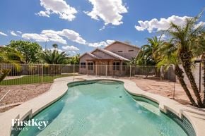 Chandler house for rent - a swimming pool with a house in the background