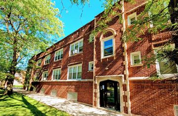 Chicago apartment for rent - A red brick building with a black door and windows.