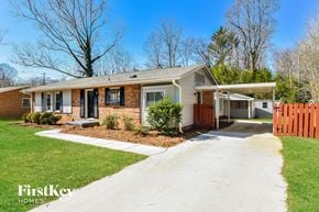 Greensboro house for rent - a small brick house with a white sidewalk in front of it