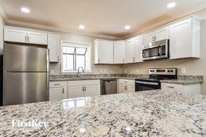 Greensboro house for rent - an updated kitchen with granite counter tops and white cabinets