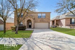 Live Oak house for rent - a large brick house with a driveway and a garage door