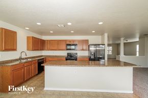 Live Oak house for rent - a kitchen with a large island and wooden cabinets