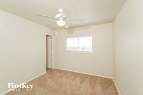 Live Oak house for rent - a bedroom with carpet and a ceiling fan
