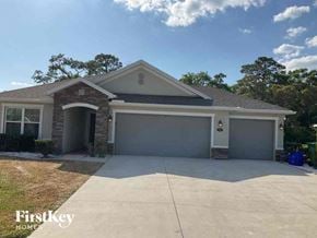 Deland house for rent - a house with a driveway and a garage door