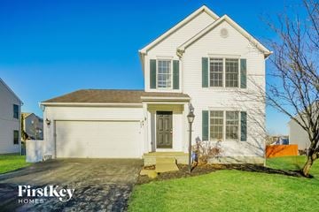 Pickerington house for rent - a white house with a driveway and a white garage door