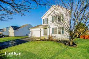 Pickerington house for rent - a white house with a lawn and a tree