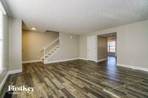 Pickerington house for rent - the living room and dining room of an empty house with wood flooring