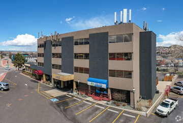 Colorado Springs apartment for rent - A large building with a parking lot in front of it.