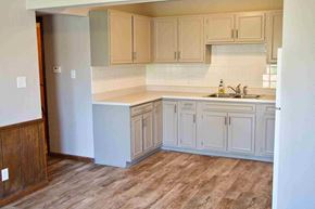 Jefferson City apartment for rent - A kitchen with wooden floors and cabinets.