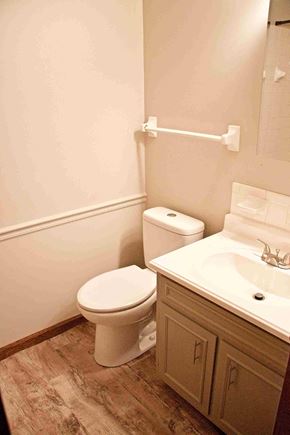 Jefferson City apartment for rent - A white toilet sits next to a sink in a bathroom.
