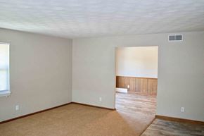 Jefferson City apartment for rent - A room with a carpeted floor and a window.