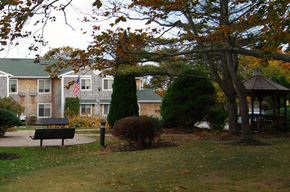 Narragansett apartment for rent - Apartment building behind trees and bushes