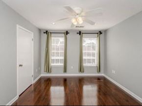 Baton Rouge apartment for rent - A room with a ceiling fan and wooden floors.
