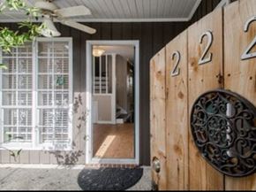 Baton Rouge apartment for rent - A wooden door with the number 22 on it and a mailbox on the right side.