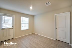 Converse house for rent - an empty room with a white door and a window