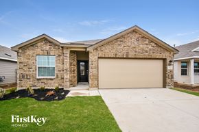 San Antonio house for rent - a house with a garage door and a lawn