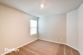 San Antonio house for rent - a bedroom with white walls and carpet and a window