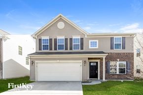 Camby house for rent - a tan house with a white garage door