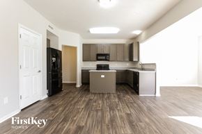 Camby house for rent - a kitchen and living room of an apartment with wood flooring and