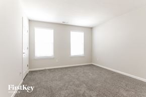 Camby house for rent - a bedroom with carpet and three windows